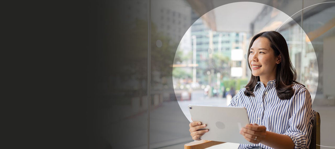 Woman sipping coffee doing work