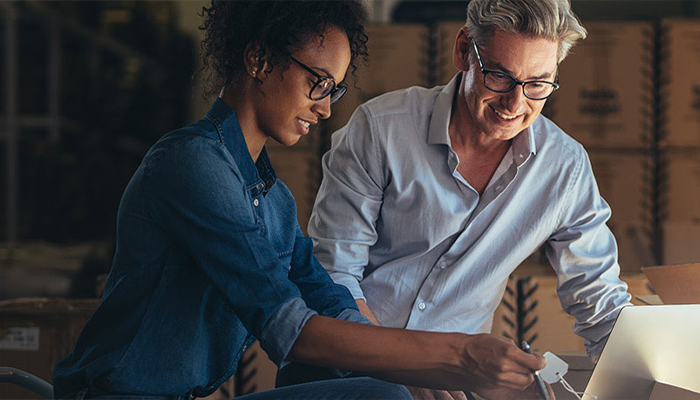 Man and woman looking at a computer pice tag