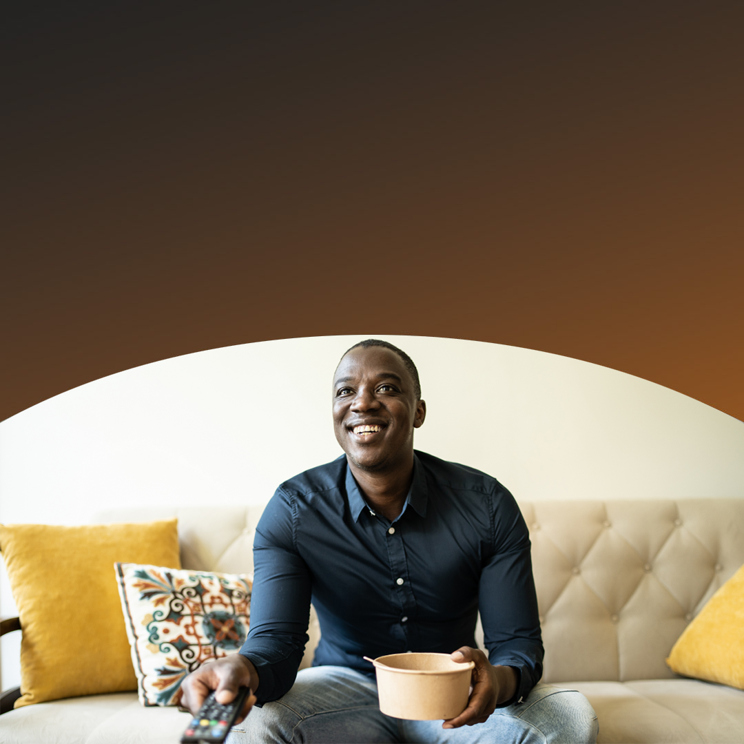 Man watching tv eating a snack