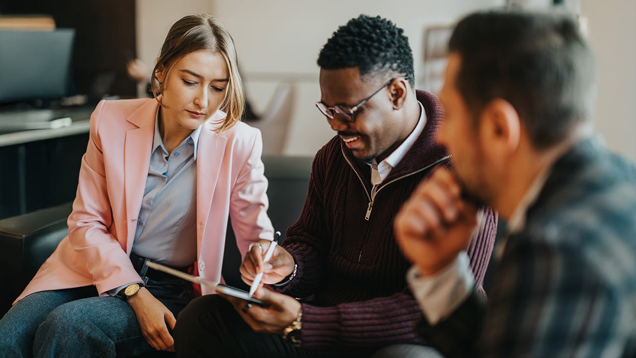 Colleagues working on a project in an office.