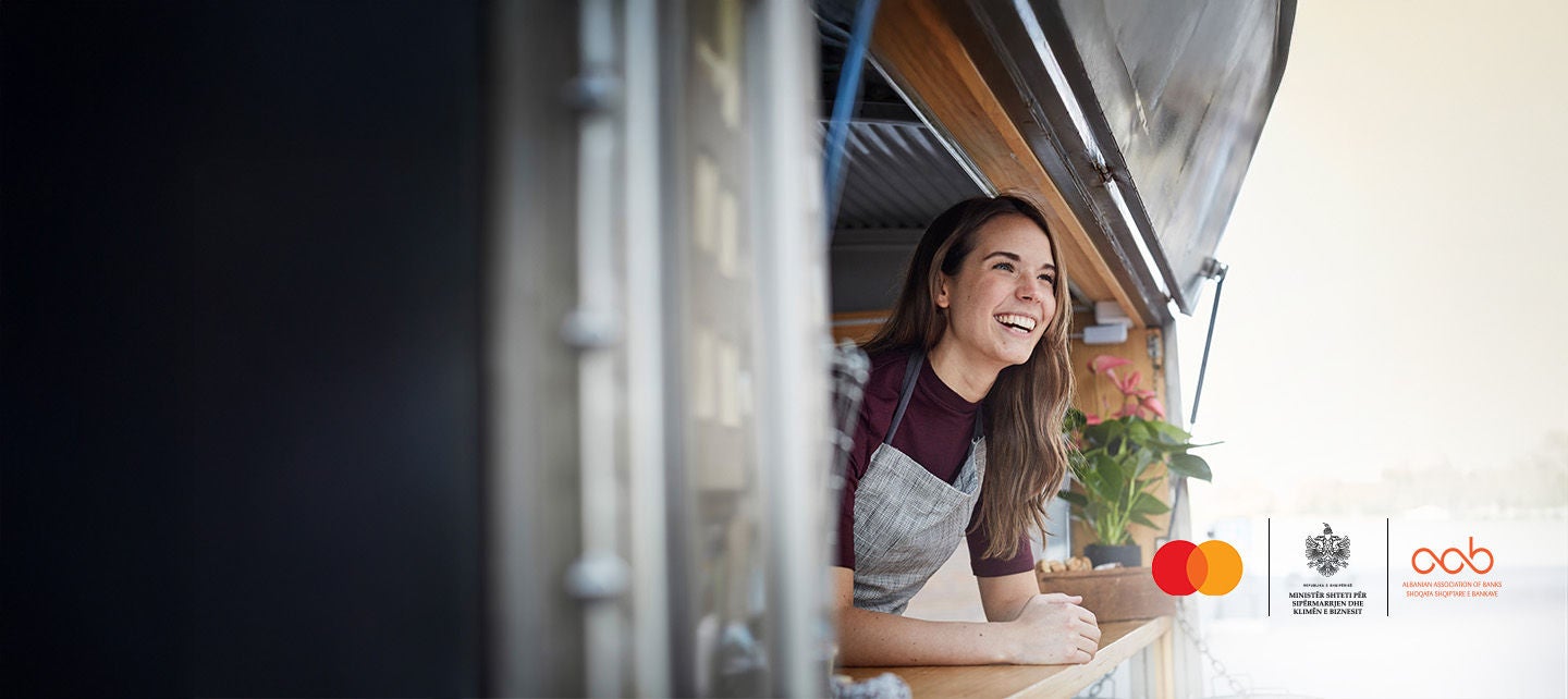woman looking at clothing rack inside mastercard logo silhouette