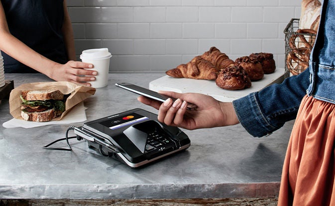 Person paying at a pastry shop