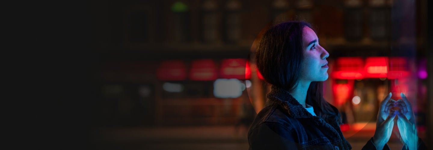 Woman looking at a board at night