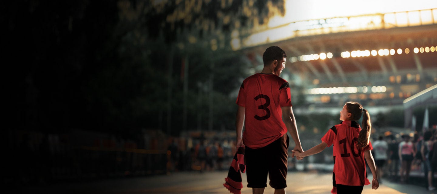 fan walking with football player