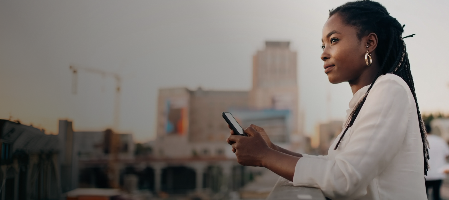 A woman with braids using her phone