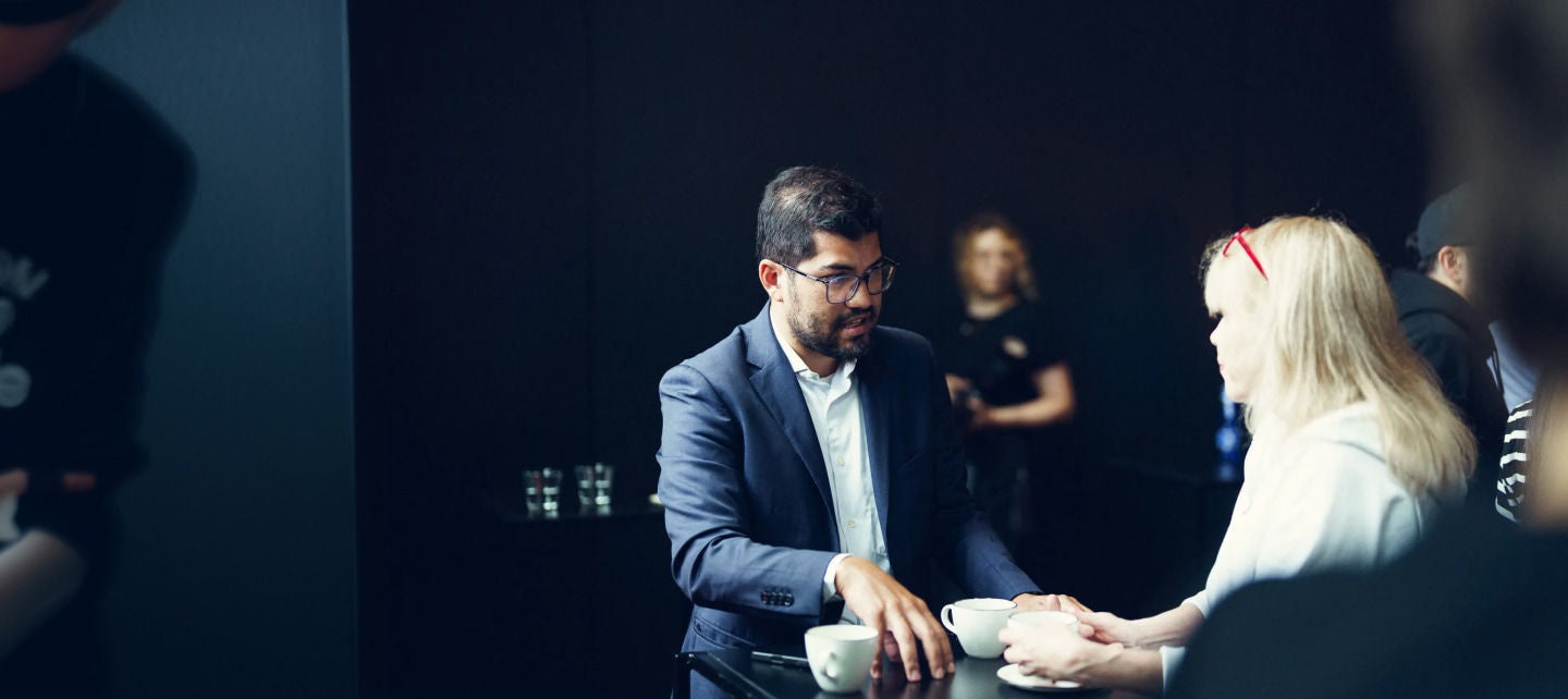 man talking to a woman business coffee