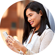 woman looking at her phone and smiling