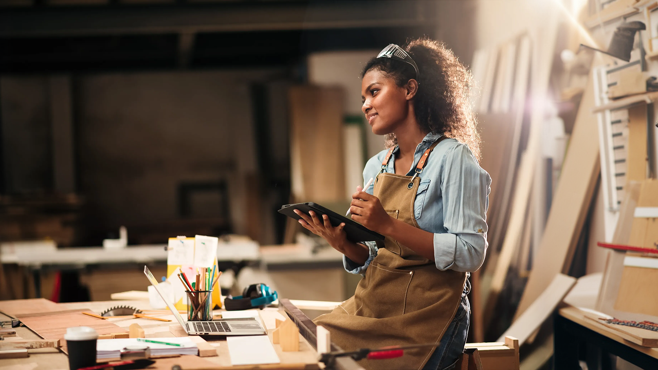 A woman in an office with a tablet