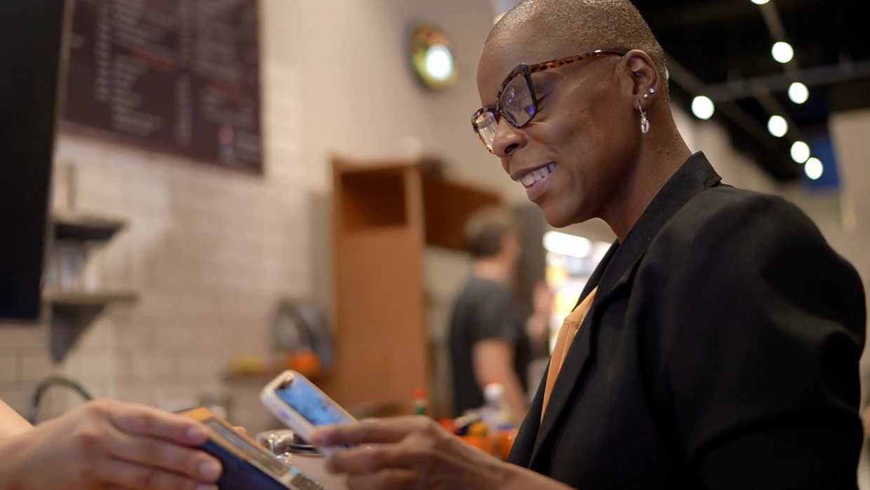 Man helping quickly oboard customer using laptop.