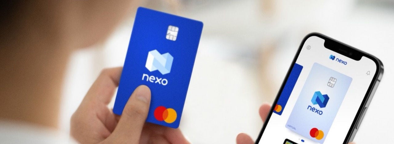 A person taps their card on a payment terminal, indicating a transaction in progress.