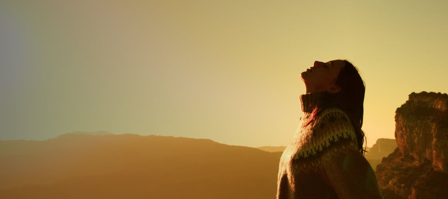 woman enjoying sunset in mountains
