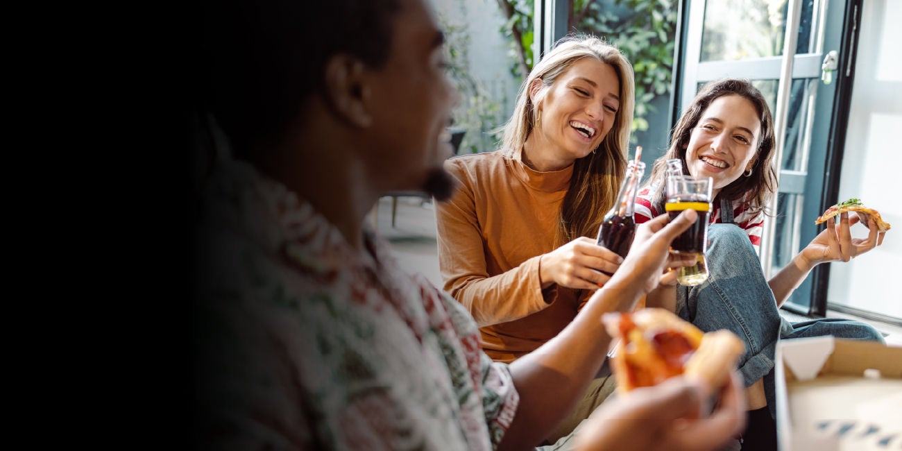 Two smiling people enjoying the benefits of being a Mastercard cardholder.