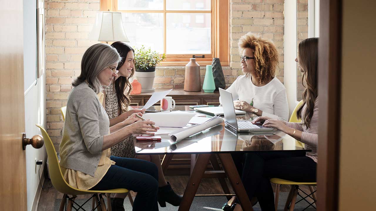 Four women collaborating on a project.