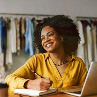 Young woman smiling while working on computer