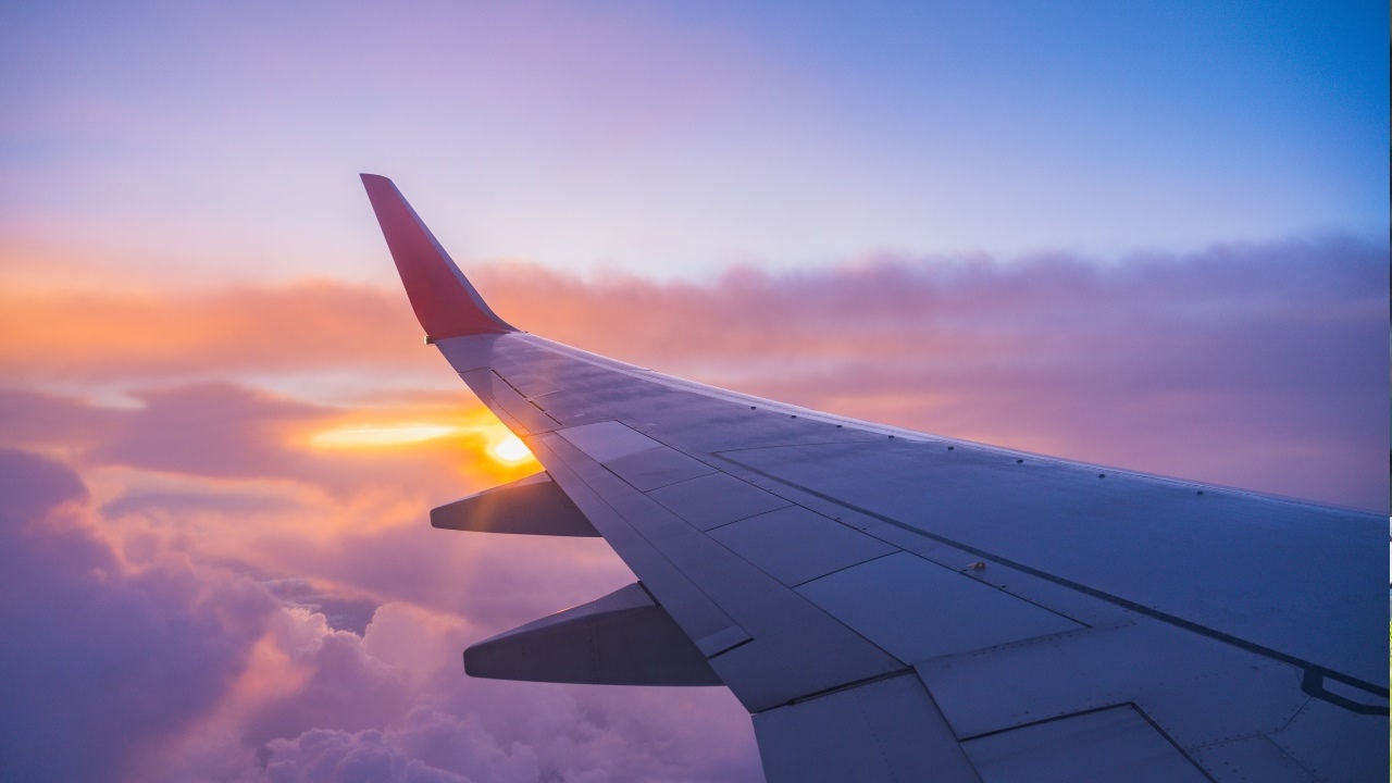 The wing of an airplane at sunset