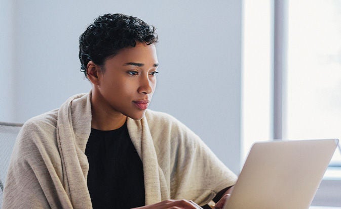 Woman using her laptop at work