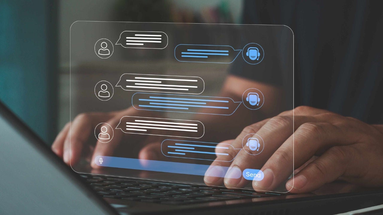 A person types on a keyboard with a screen showing a chat with a chatbot superimposed on it. 