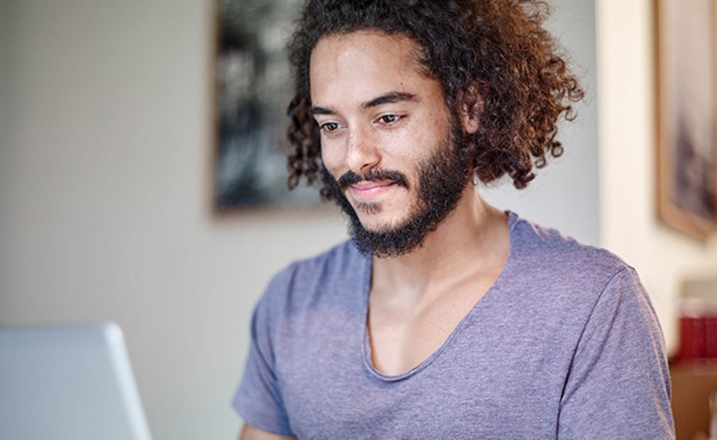 Young bearded man using a laptop