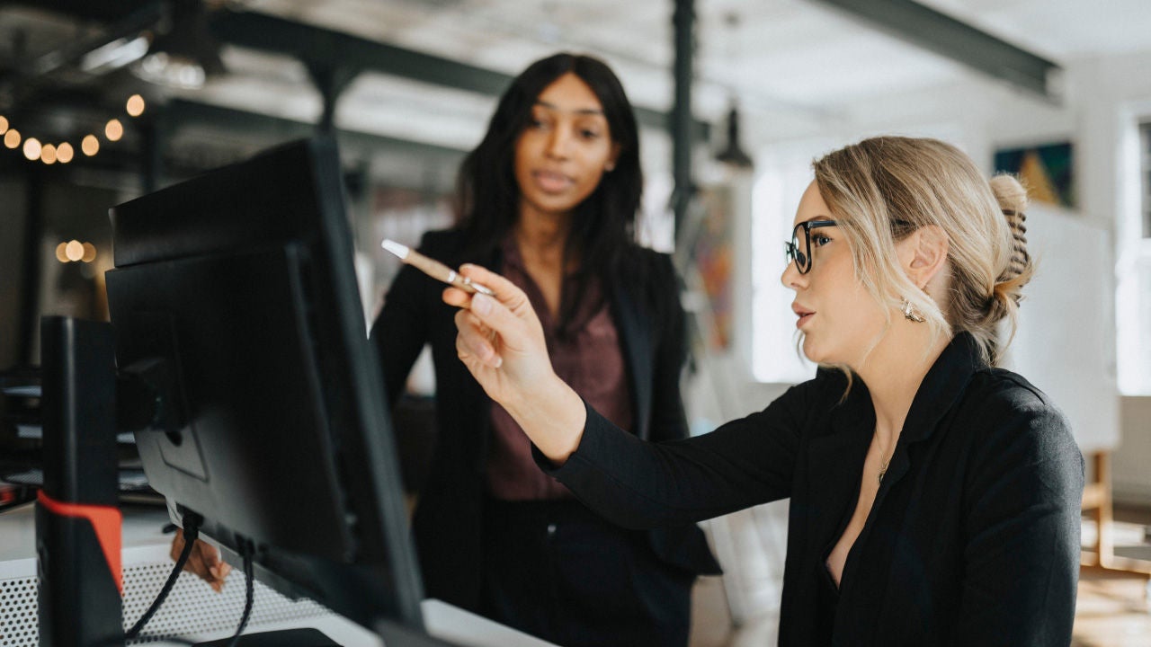 Woman pointing at computer screen