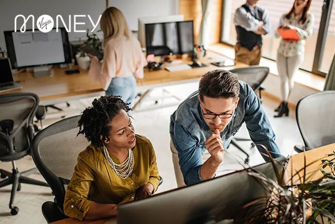Woman and man staring intently at computer screen.