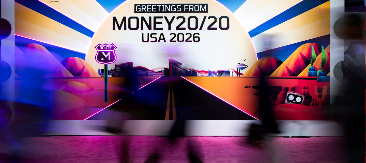 People move past a Money 20/20 banner