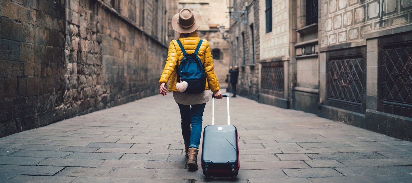 Woman walking with a bag through a city