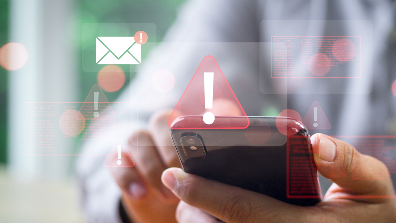 A person taps on a cell phone with illustrations of alerts popping up. 