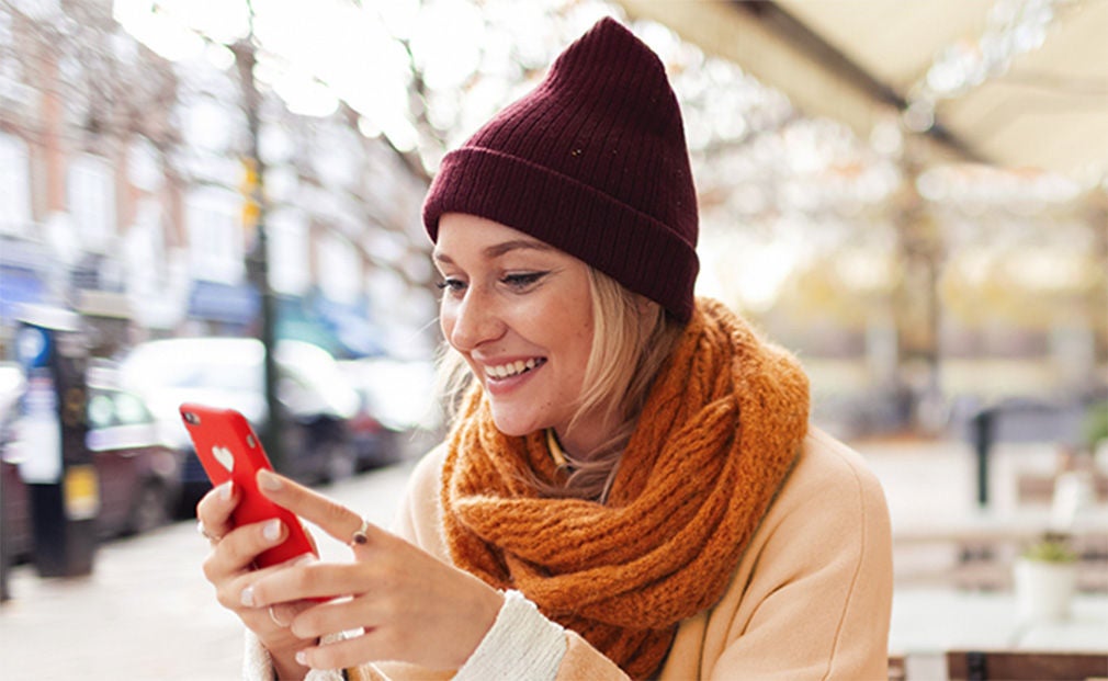 Woman wearing a hat using her phone