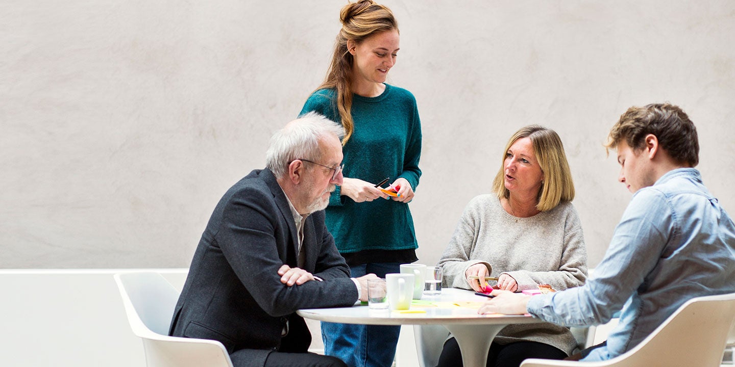 Colleagues gathered around a table for a business meeting