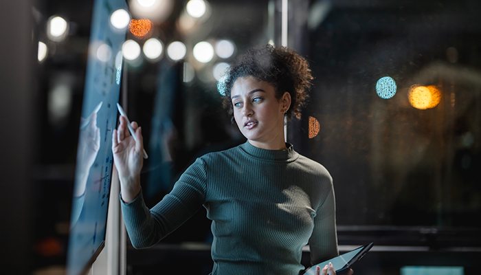 Man using his phone wearing a red bag