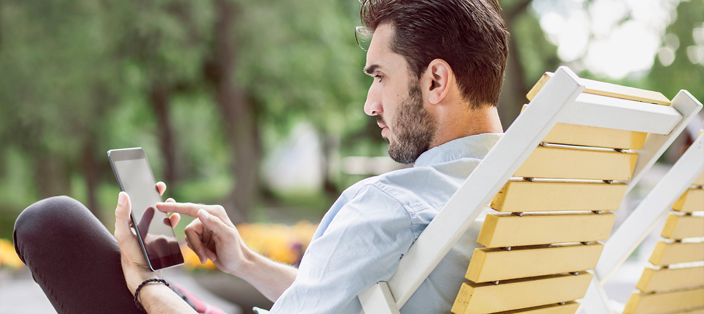 Man in a red sweater using his phone
