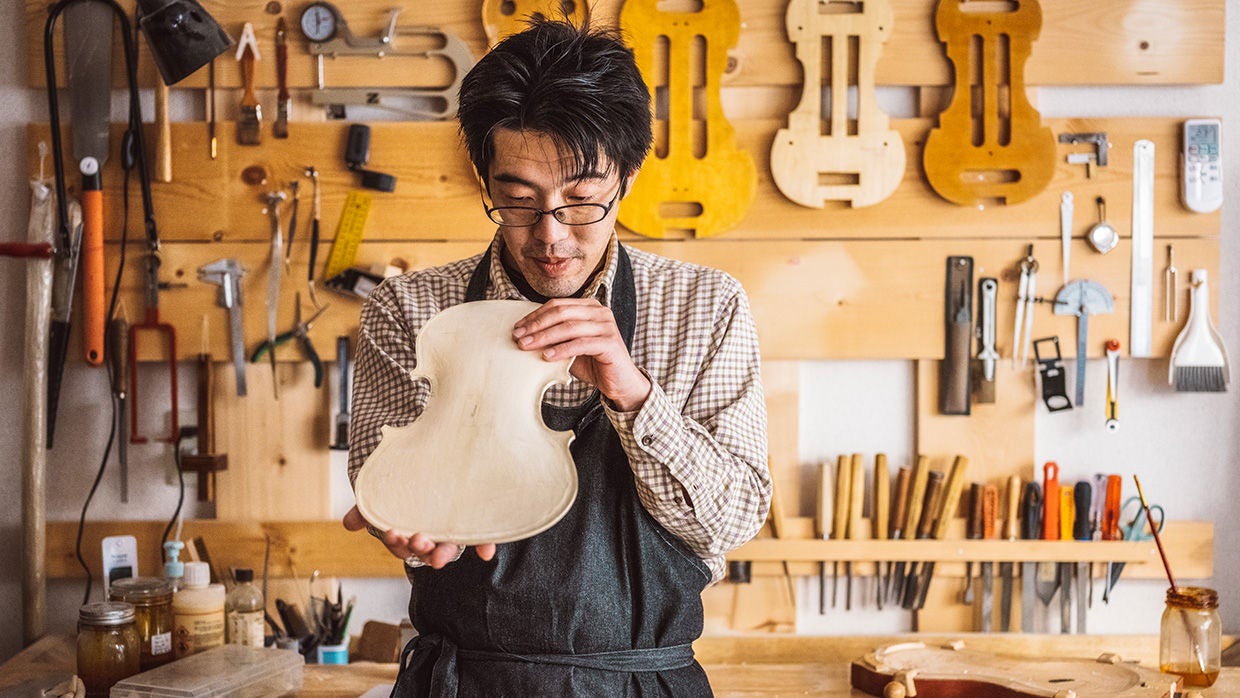 small  business asian man working on violin