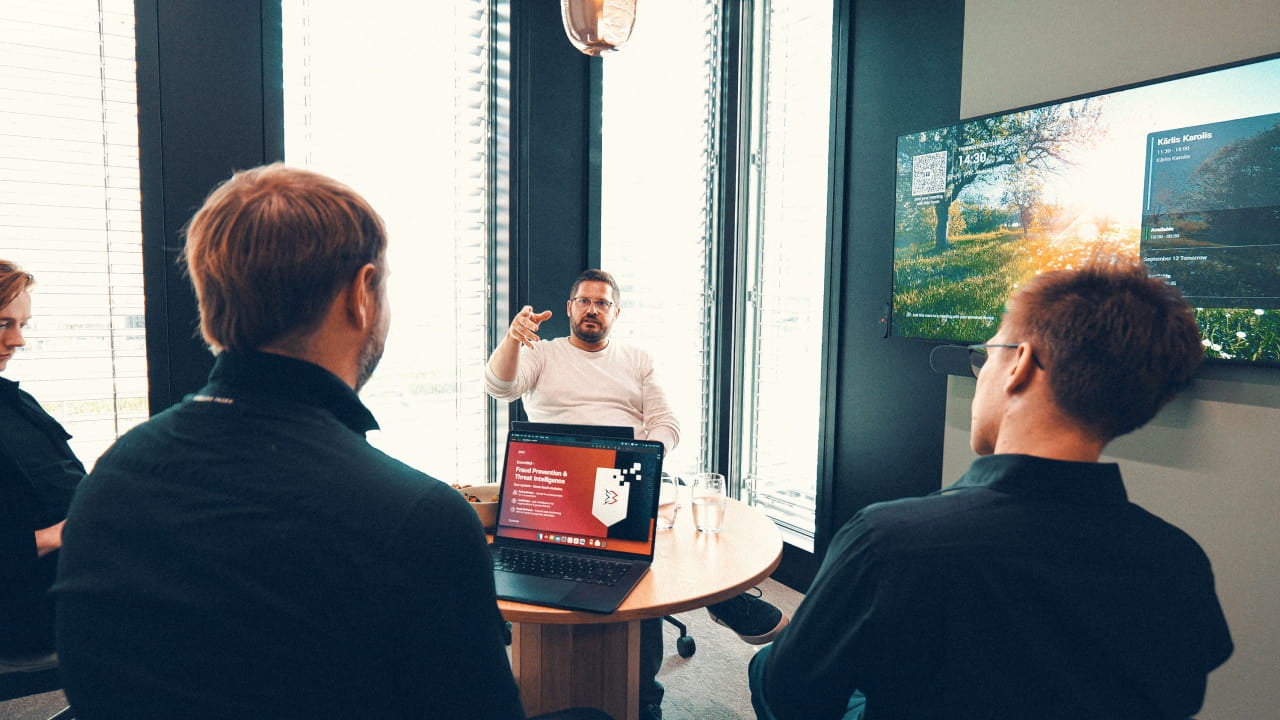 man presenting laptop office meeting