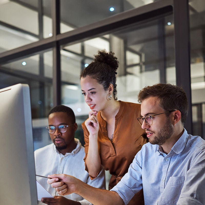 Coworkers looking at a computer