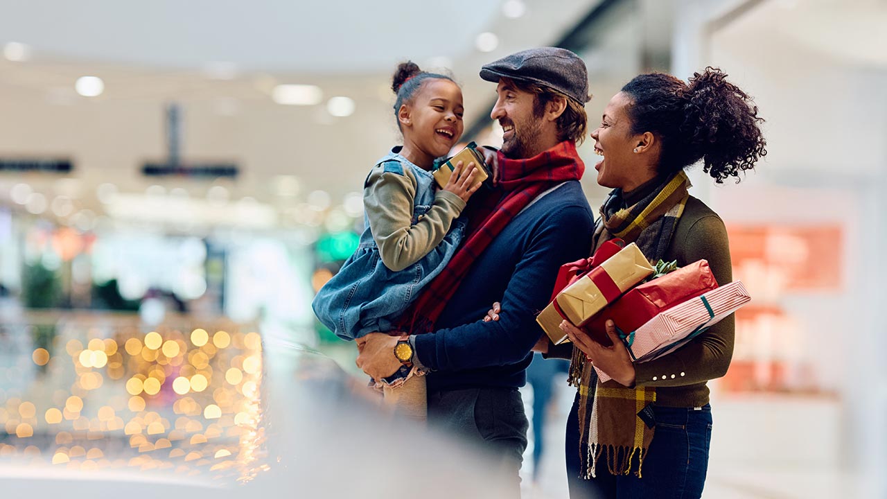 Family in mall, shopping for holiday gifts.