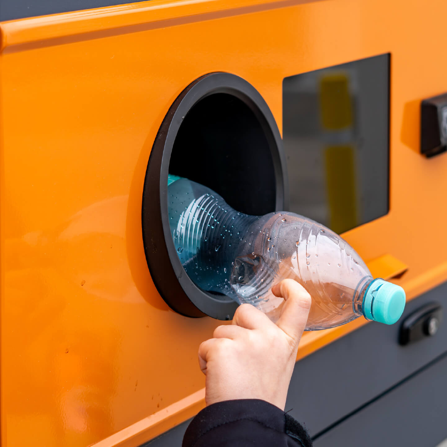 Plastic bottle recycling into an orange hole