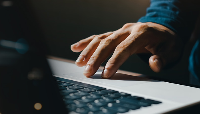 Hand on a computer trackpad