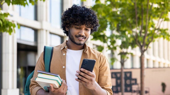 Man looking at phone outside