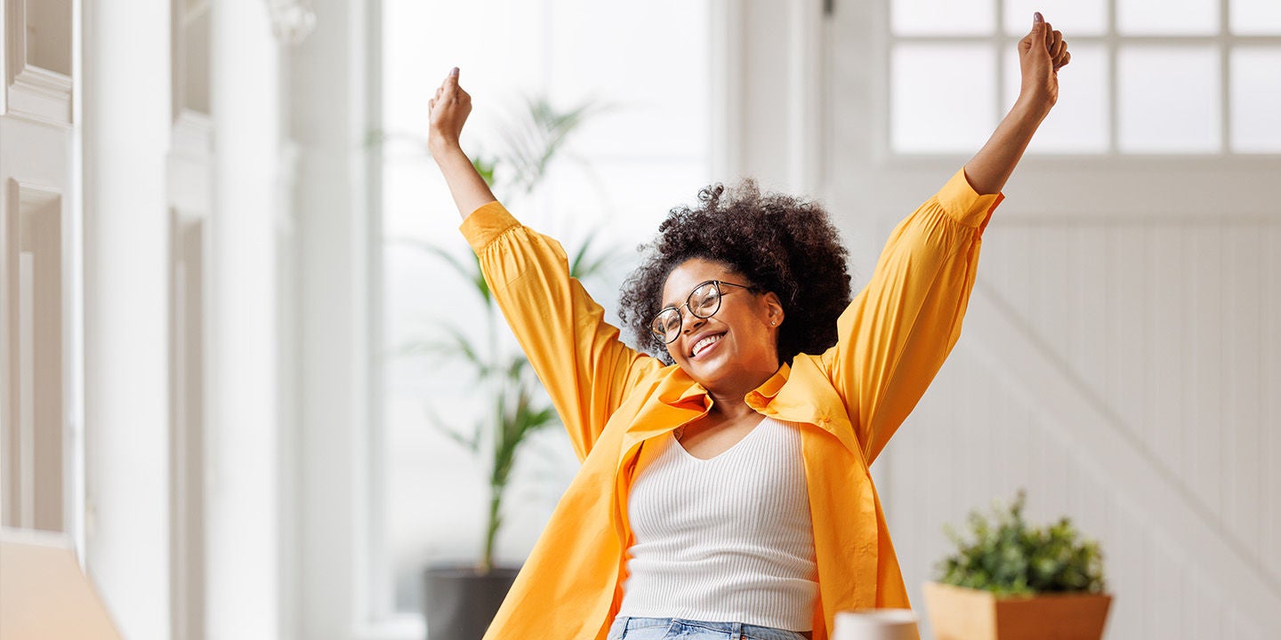 Happy woman with her hands up in the air