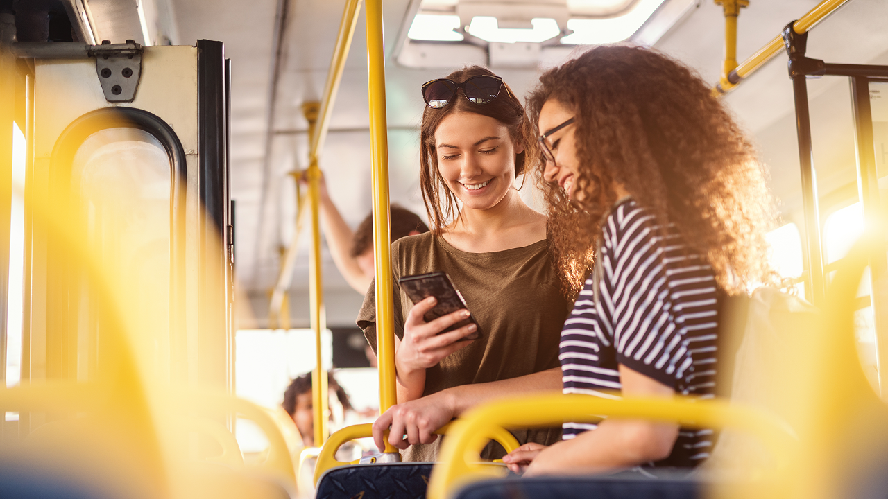Two women in bus standing