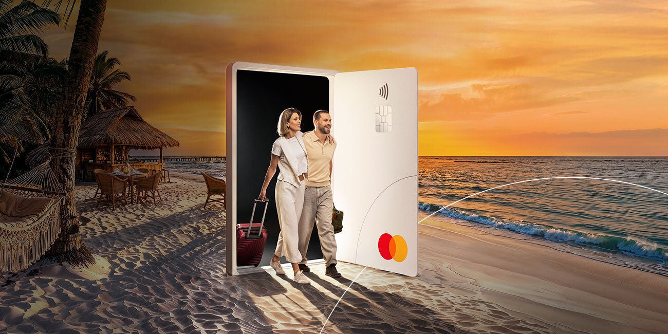Two smiling people enjoying the benefits of being a Mastercard cardholder.