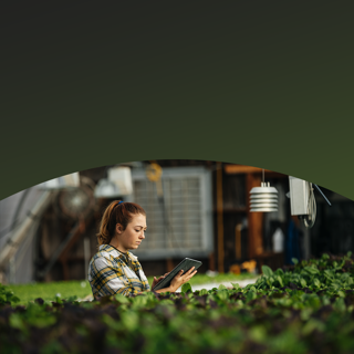 woman in garden using a tablet to conduct business