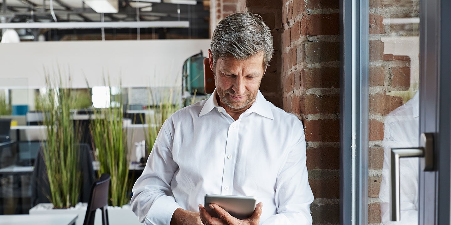 Businessman in office looking at digital tablet