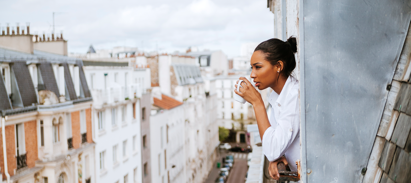 Woman looking out on a balcony