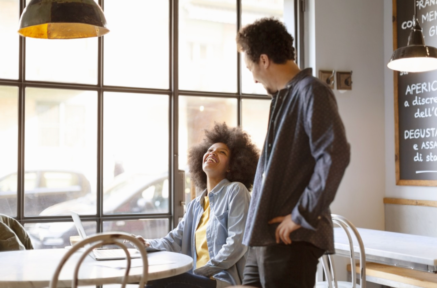 Man and Woman smiling while looking at a computer