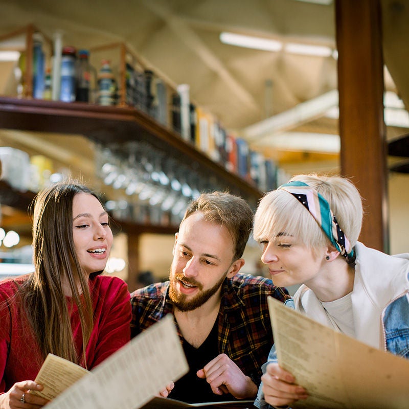 People at a table looking at a menu
