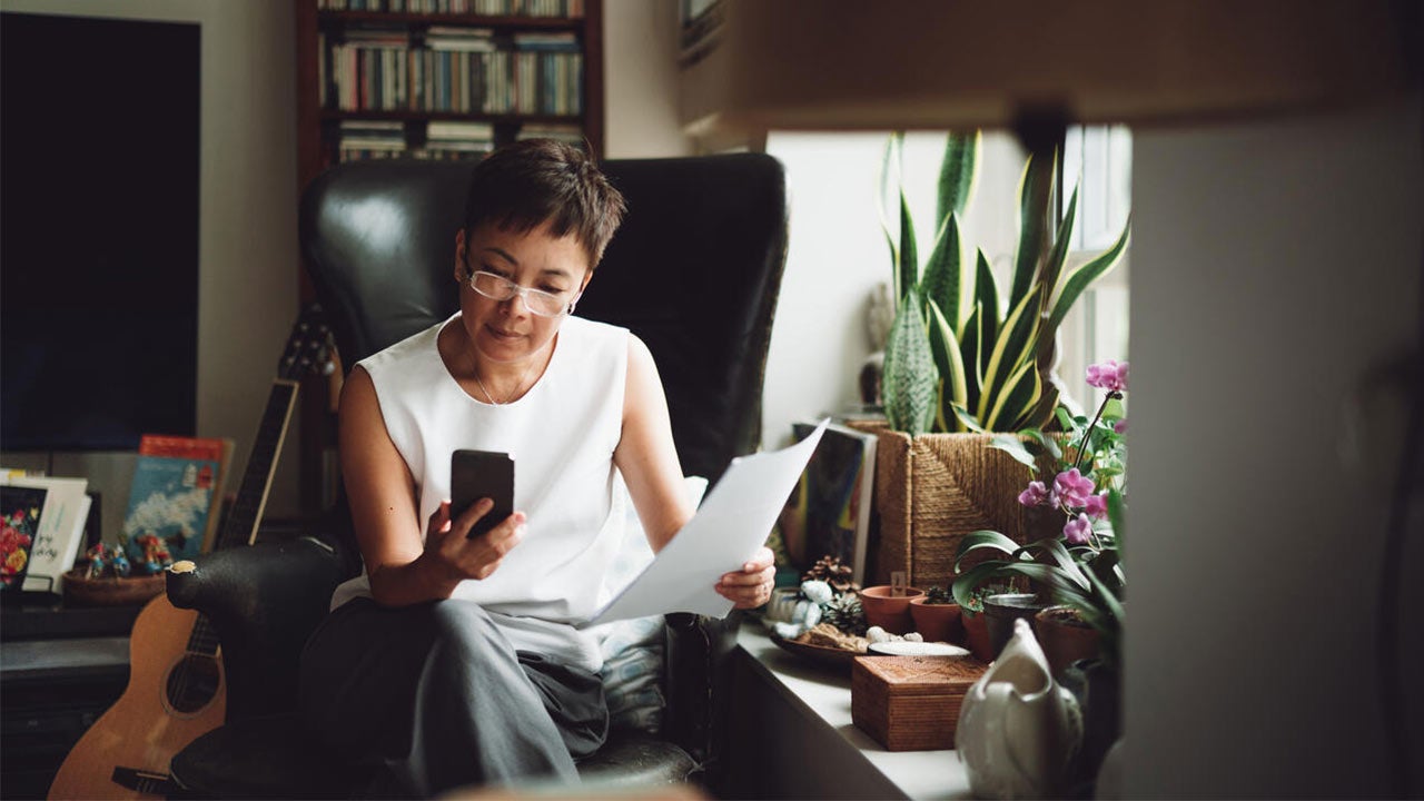 A woman using smartphone to settle financial bill.