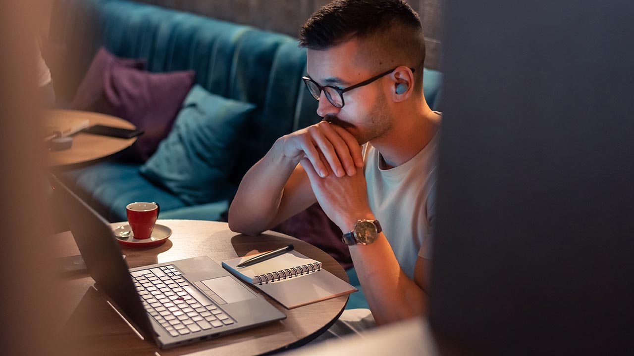 Young man working on a laptop.