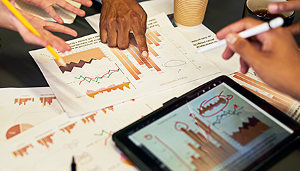 People reviewing graphs on a desk