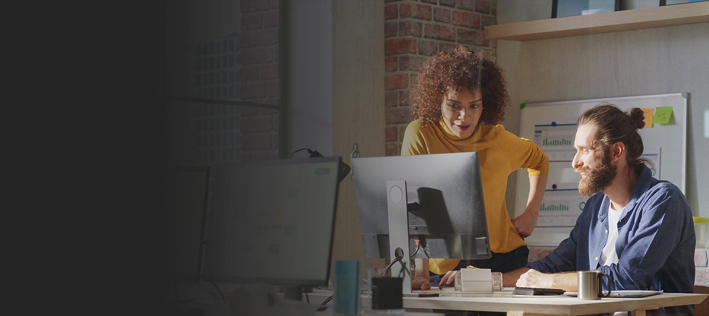 Women holding phone in one hand and payment card in the other hand.